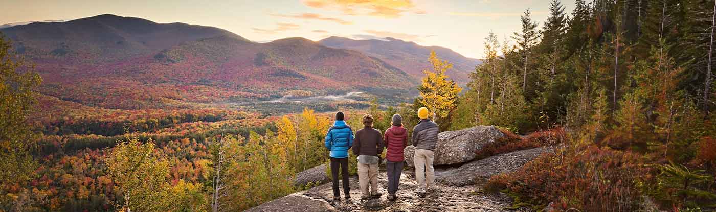 hikers overlooking the adirondack mountains in the fall