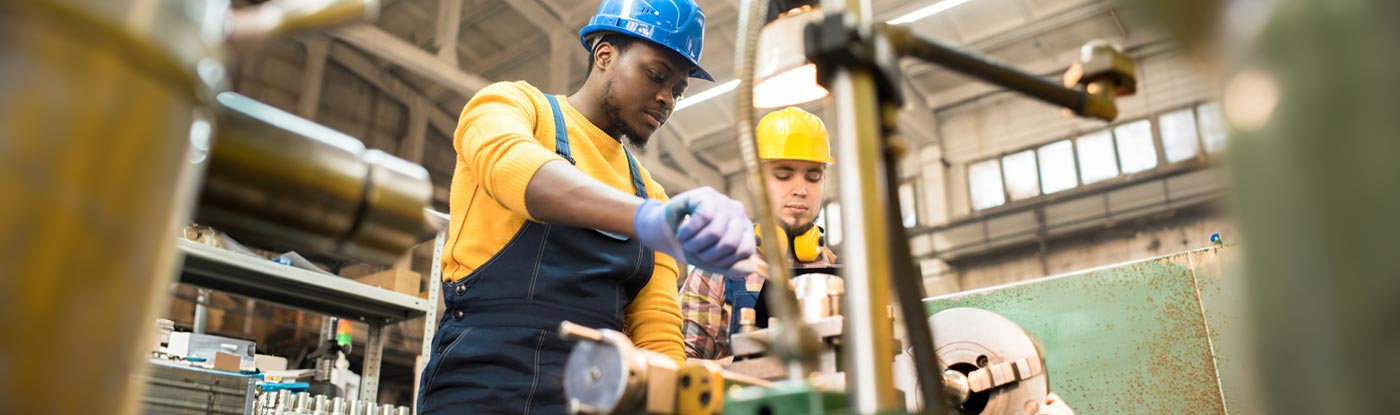two factory employees working together