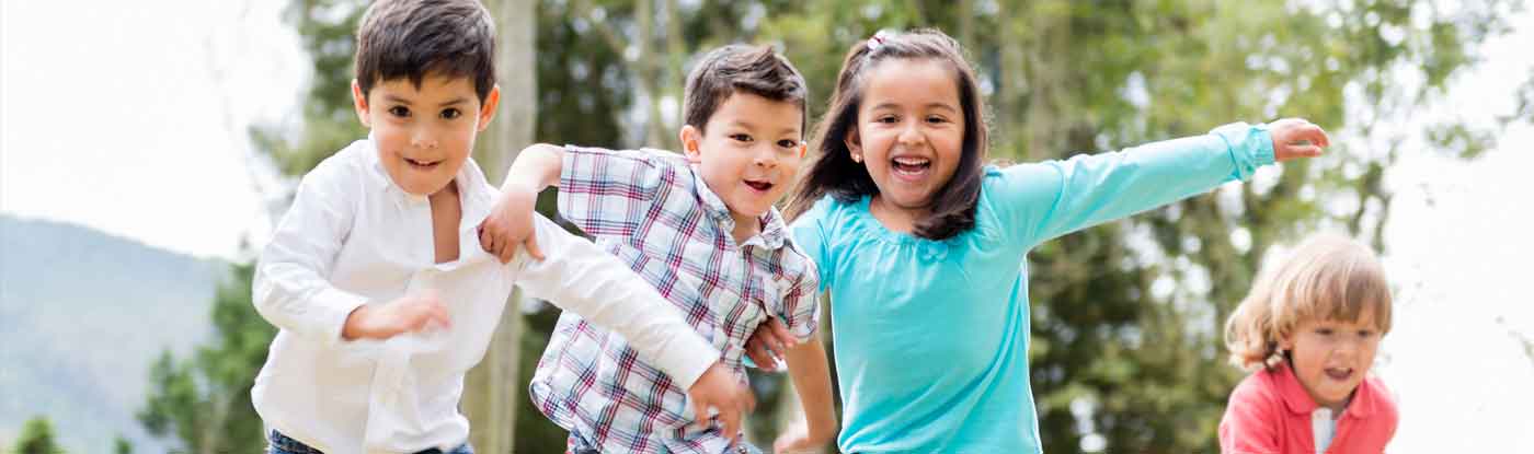 A group of children running and playing on a sunny day